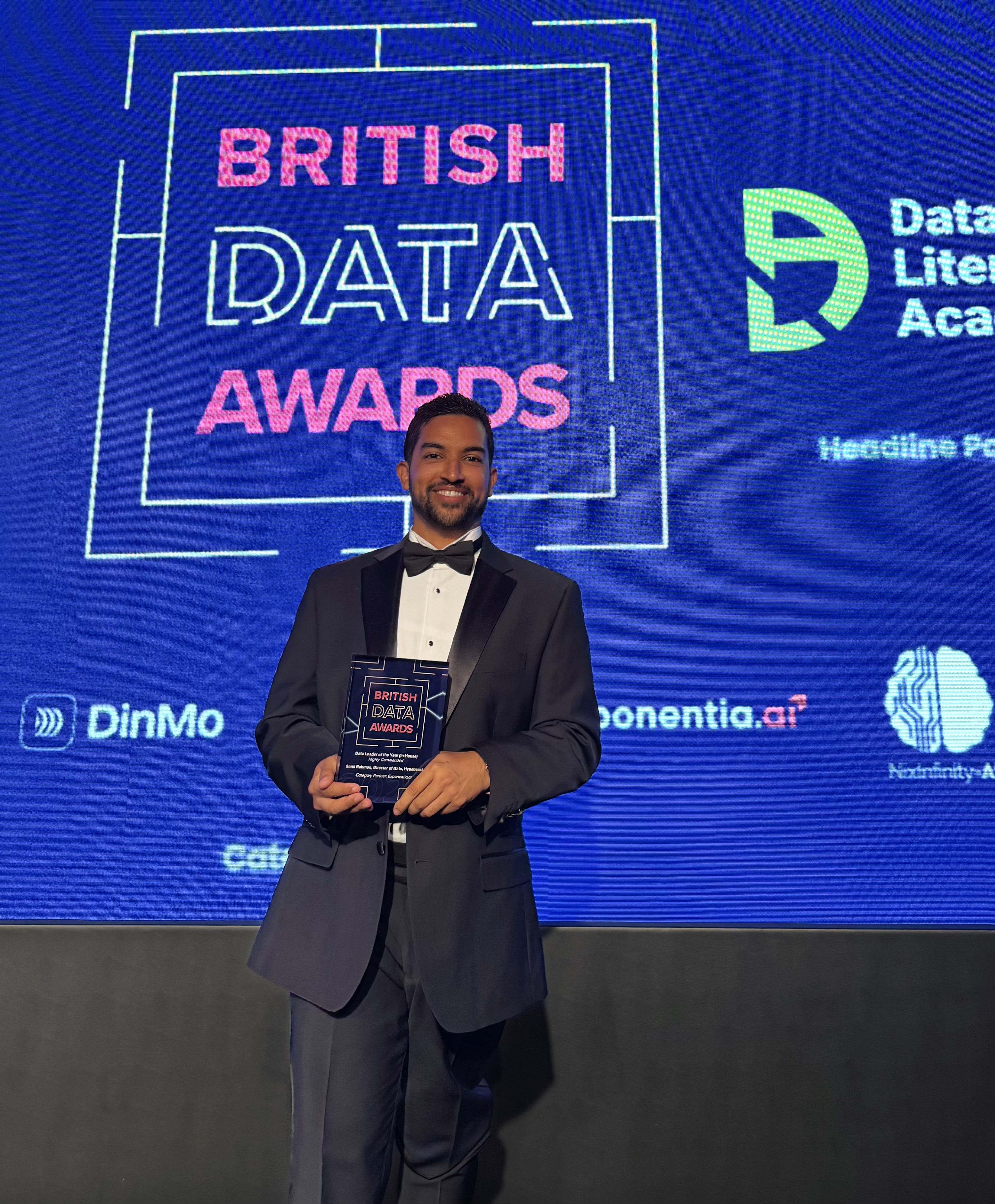 Sami Rahman holding British Data Awards trophy